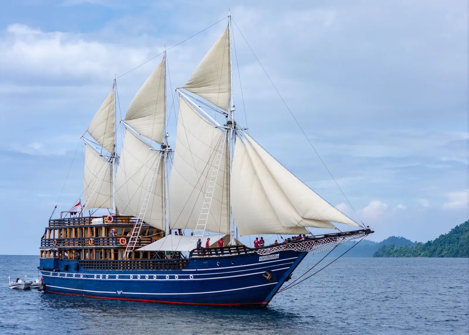 Amira liveaboard – Phinisi schooner sailing with full sails raised – Indonesia.