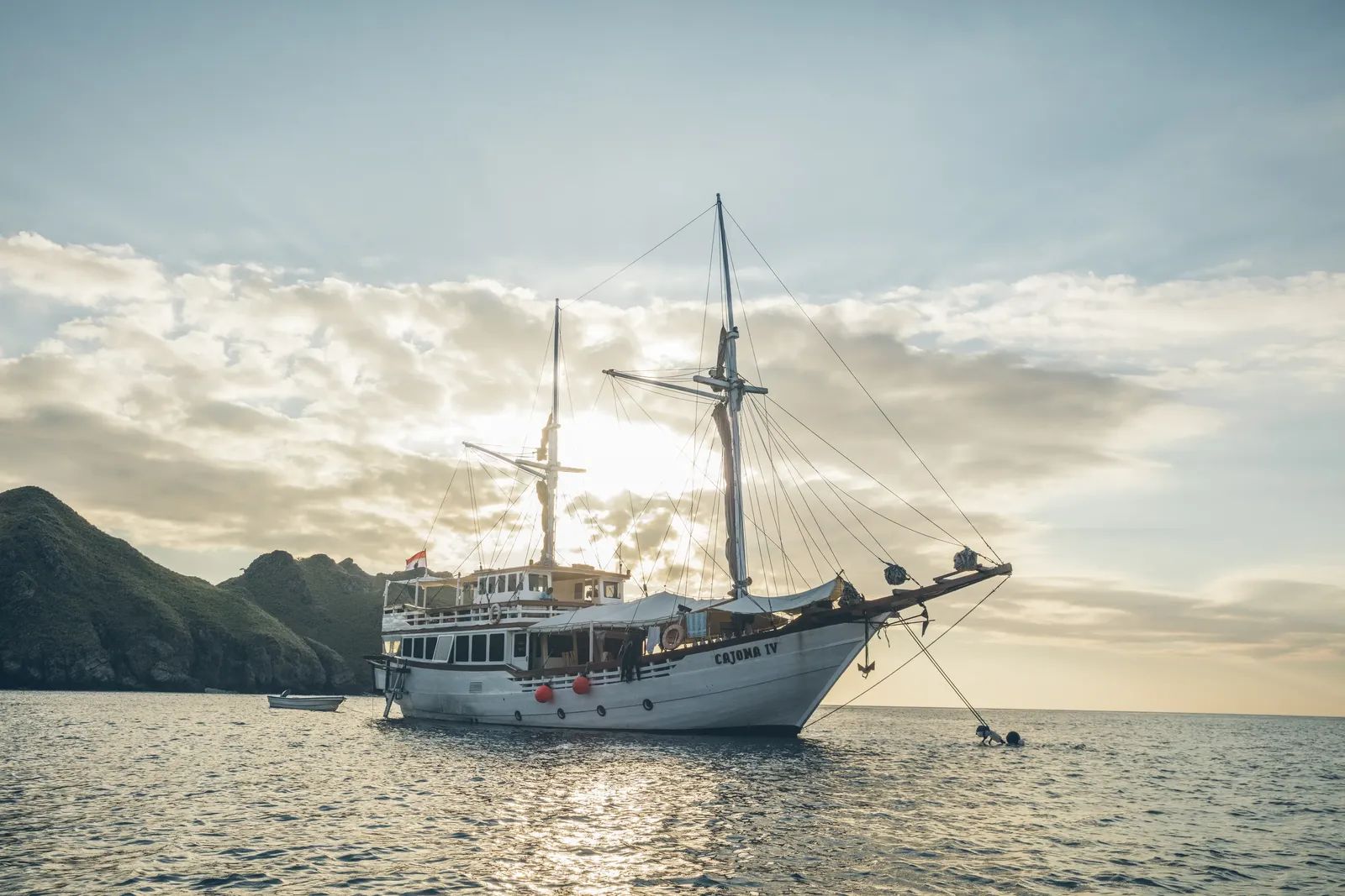 Cajoma IV liveaboard – phinisi at anchor at sunset – Komodo, Indonesia