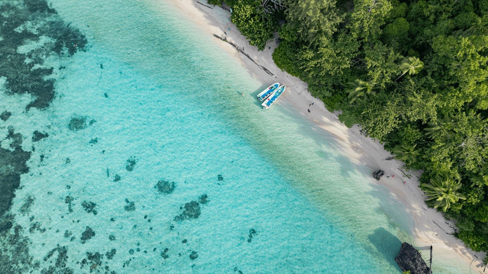 Liveaboard diving tenders on pristine Indonesian beach