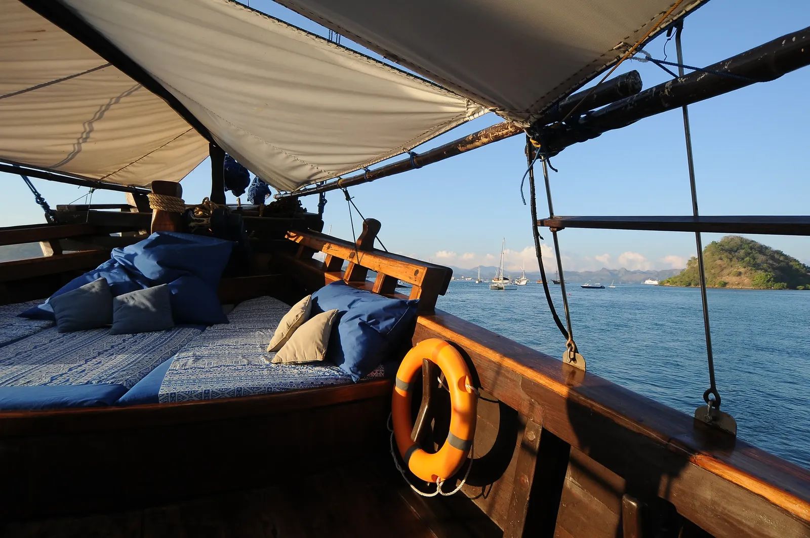 Moana Cruising liveaboard – bow seating with life ring and harbor view – Komodo, Indonesia