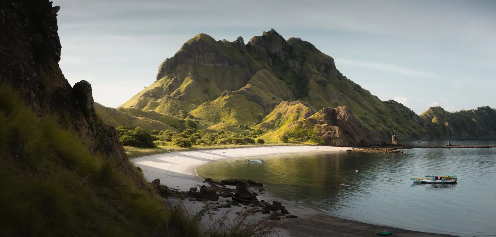Naga Biru liveaboard – scenic beach and limestone hills – Komodo, Indonesia