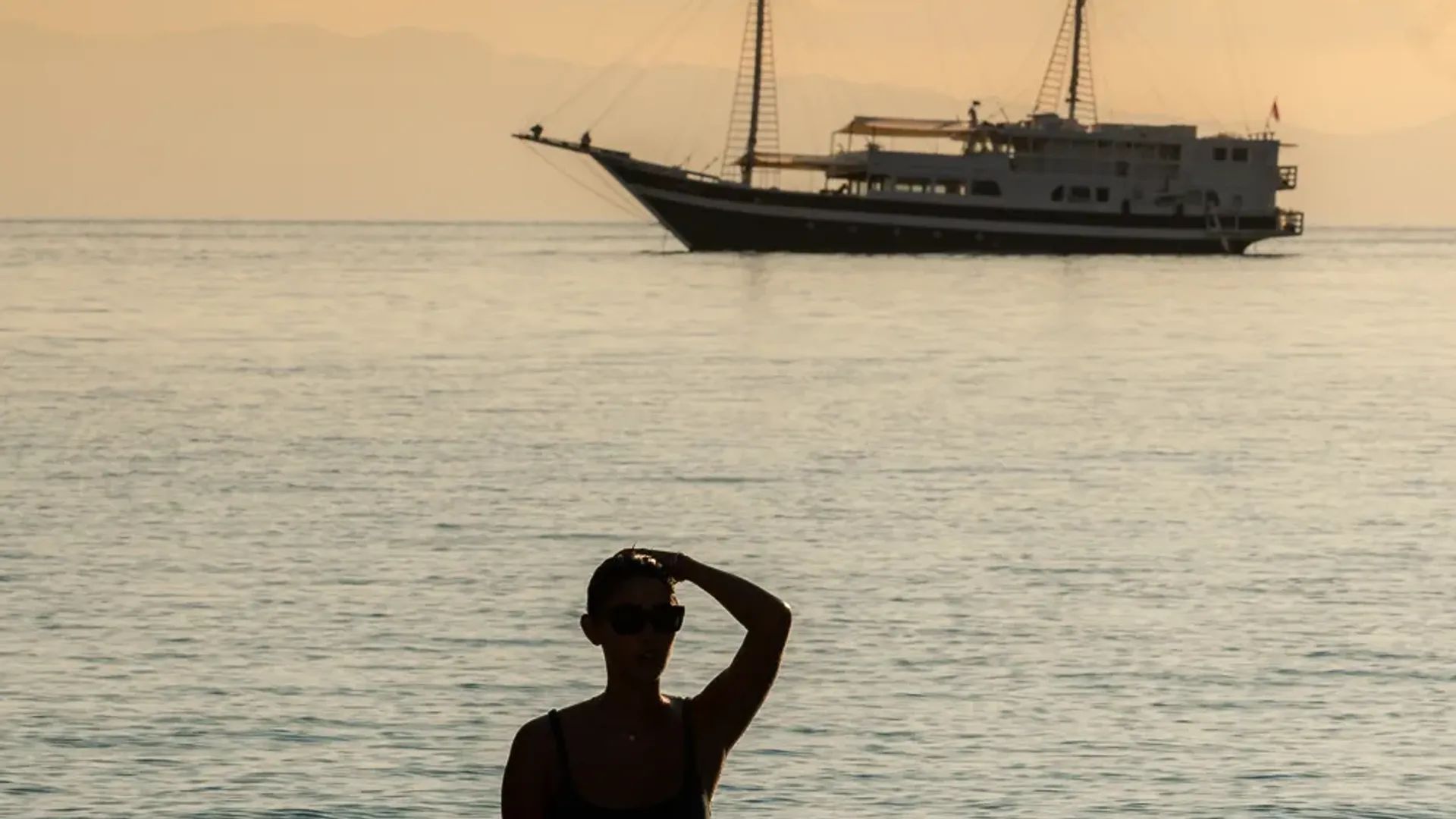 Woman silhouette sunset luxury liveaboard Indonesia