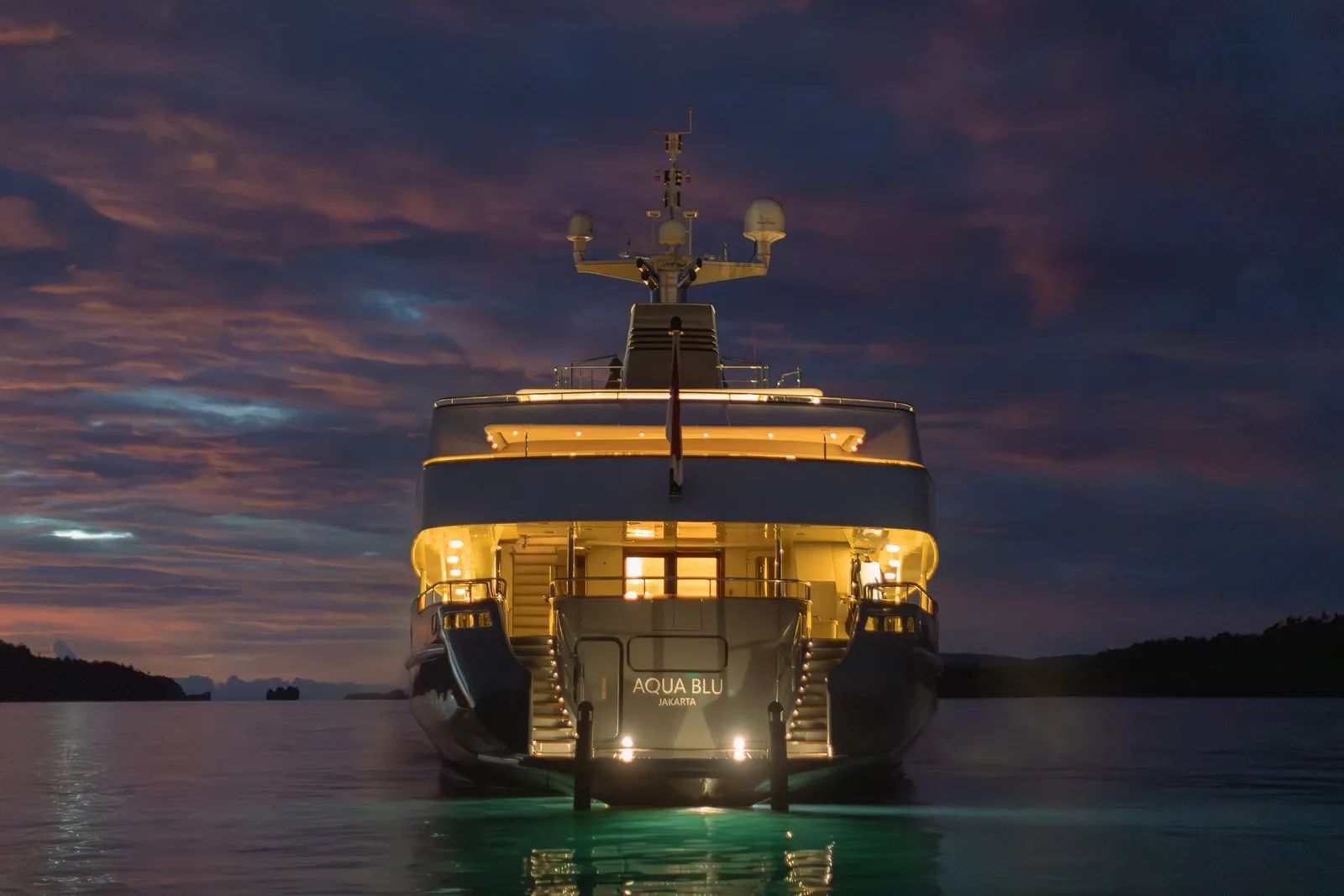 Aqua Blu liveaboard – stern view of the yacht at night showing the vessel name – Indonesia