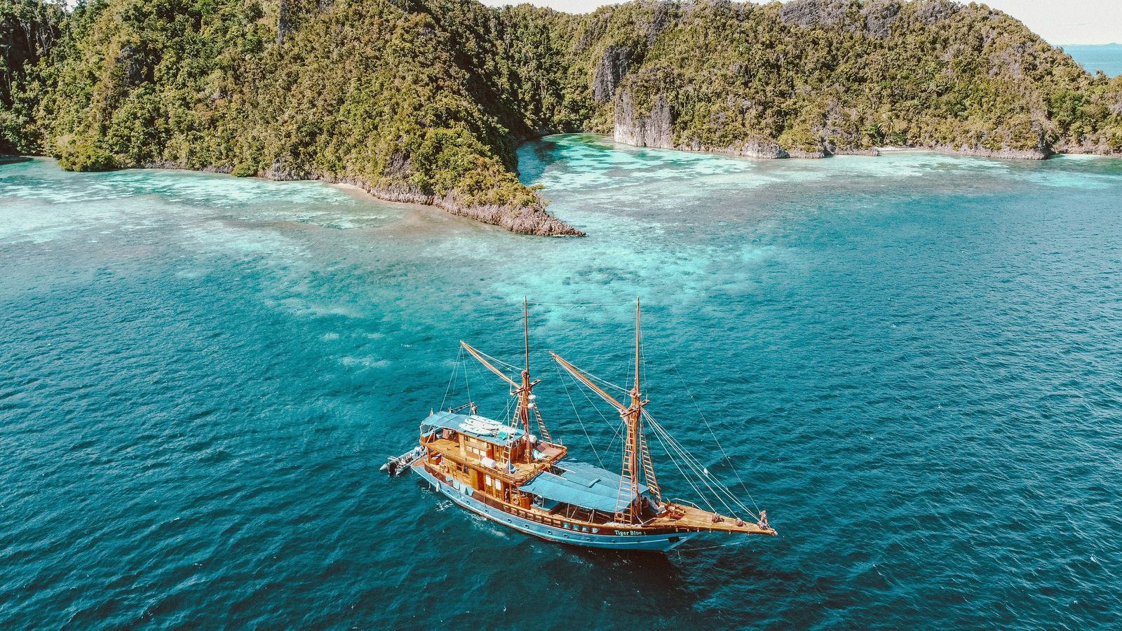 Indonesian liveaboard boat turquoise waters pristine diving destination coral reef